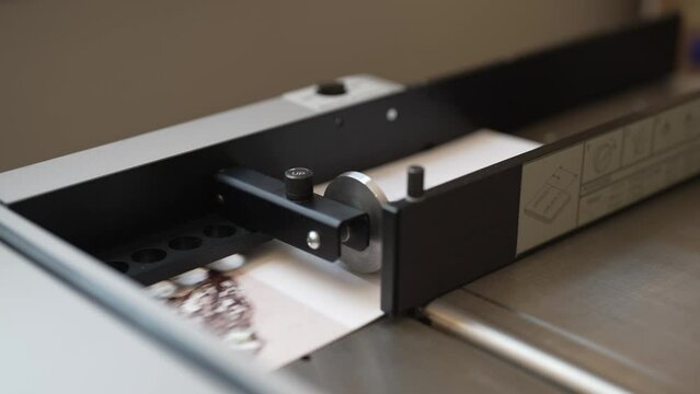 An industrial creasing machine scores folded greeting cards