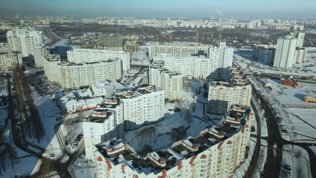 City quarters. Multi-story houses. Houses under construction and shopping centers are visible. Winter cityscape. Aerial photography.