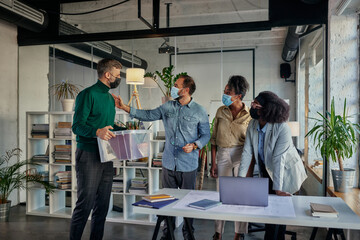 Businessman with belongings coming back in office