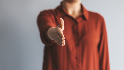 Happy office employee giving hand for shaking . Arm of business woman offering handshake....