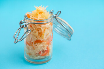 salted cabbage with carrot in glass jar
