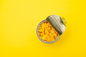 canned food corn in iron on yellow