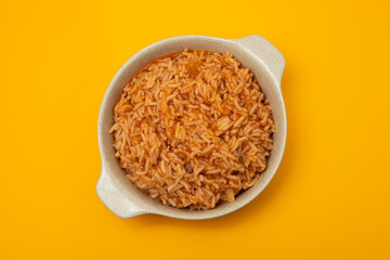 tomato rice on the dish on yellow background