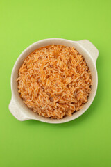 tomato rice on the dish on green background