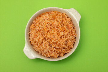 tomato rice on the dish on green background