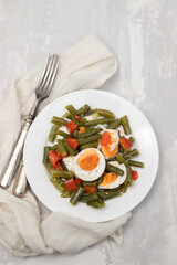 healthy salad green beans, pepper and boiled eggs on plate