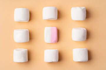 Fluffy marshmallows on beige studio background, top view