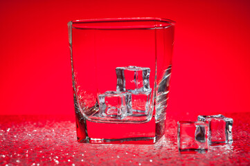 Glass transparent glass with ice cubes for cooling drinks.