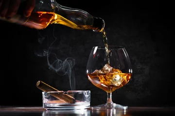 Fototapeten Pouring a whiskey in a glass on bar counter © Alexander Raths