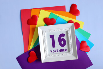 day of the month 16 November calendar .    Calendar date in a white frame on a rainbow background