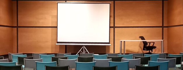 shot of a modern empty classroom or conference room with seats and a blank whiteboard for mockup....
