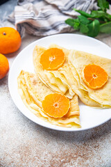 sweet crepe citrus thin pancake breakfast Shrovetide holiday Maslenitsa dessert pancakes meal food snack on the table copy space food background
