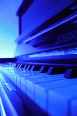 piano keyboard close up, piano keys in blue light