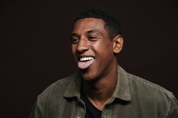 Young black man dressed in shirt laughing while showing his tongue