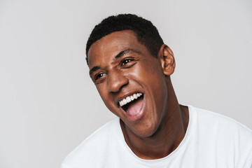Young black man in t-shirt laughing and looking at camera