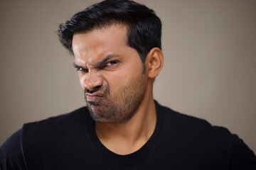 Fototapeta premium Portrait of a young man frowning angrily at the camera
