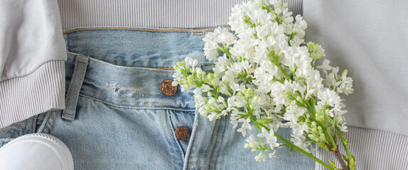 Denim jeans and white lilac flowers banner