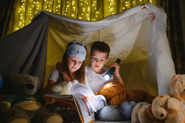 Fototapeta na wymiar Little children reading bedtime story at home