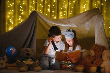 Fototapeta na wymiar Little children reading bedtime story at home