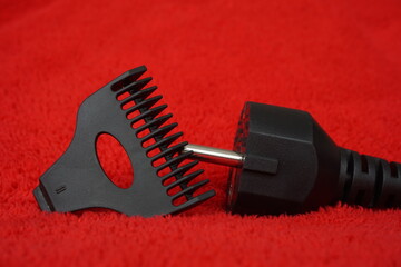 plug cord and razor head, isolated on red background
