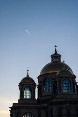 Plane over church domes