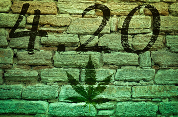 Happy 4:20 Marijuana Leaf, Cannabis Celebration. Text on an old stone wall. Photo montage