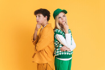 White puzzled girl and boy holding their chins while looking upward