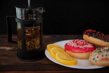 fresh donut on white plate and tea with lemon
