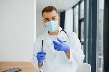 Medical doctor holds vaccine for a patient.