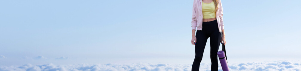 A young slim athletic girl in sportswear performs a set of exercises. Fitness and healthy lifestyle  against the background of clouds sky.