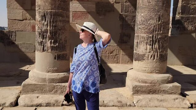 Beautiful woman tourist in Philae Temple Complex. Temple Of Isis. Philae, Agilkia Island, Aswan, Egypt