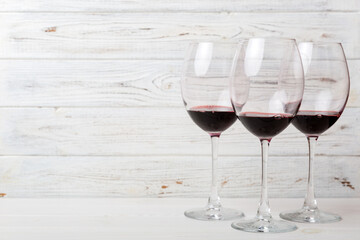 Many glasses of red wine at wine tasting. Concept of red wine on colored background. Top view, flat lay design