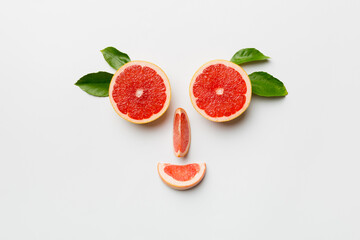 fresh Fruit grapefruit with Juicy grapefruit slices on colored background. Top view. Copy Space. creative summer concept. Half of citrus in minimal flat lay with copy space