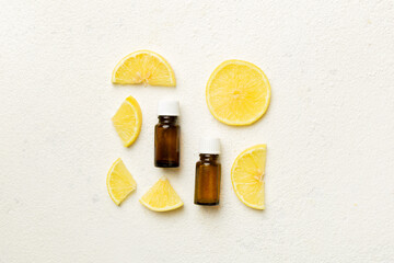 Bottles with lemon fruit essential oil on wooden background. alternative medicine top view with...