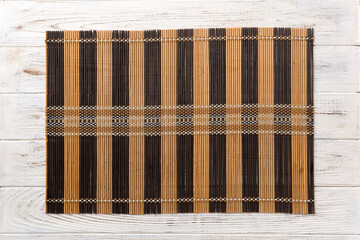 Top view of brown tablecloth for food on wooden background. Empty space for your design