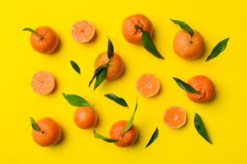 Many fresh ripe mandarin as colored background, top view. Elegant background of clementines and mandarin slices Top view flat lay