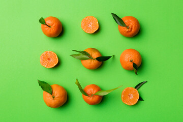 Many fresh ripe mandarin as colored background, top view. Elegant background of clementines and mandarin slices Top view flat lay