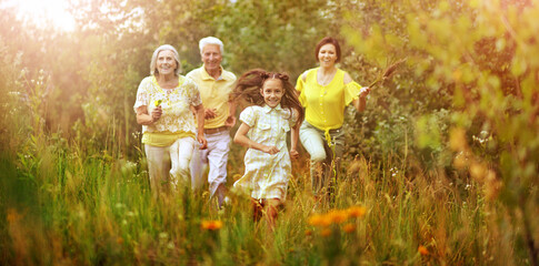 happy family running in field