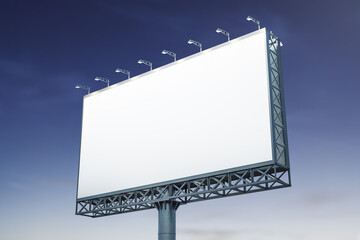 Obraz premium Blank white billboard on blue sky background at evening, perspective view. Mockup, advertising concept