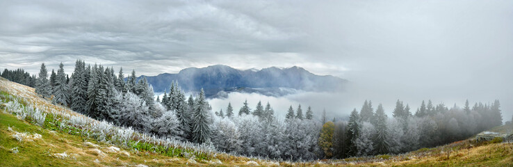 Mountain panorama in winter - cloudy sky and fog