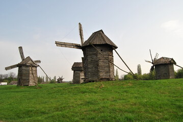 Fototapeta na wymiar Rural landscape with a mill. Folk architecture and everyday life of Ukraine. Mill. Windmill. Ukraine. Kiev.