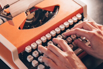 Hands typing on a retro typewriter. Business concepts. Retro picture style. Archive