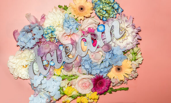 word dream over bright flower background isolated over pink with copy space for text