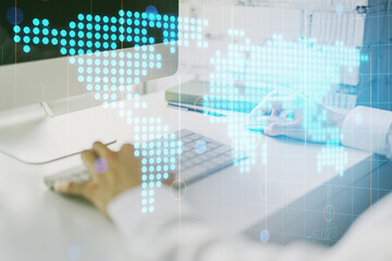 Multi exposure of abstract graphic world map and hands typing on computer keyboard on background, big data and networking concept
