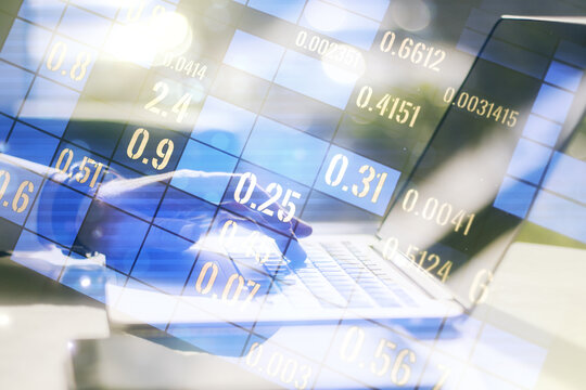 Multi exposure of abstract statistics data hologram interface with hands typing on computer keyboard on background, computing and analytics concept