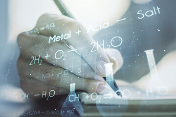 Creative chemistry illustration with woman hand writing in diary on background, science and...