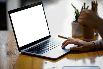 Close up of Young woman working on his laptop with blank copy space screen for your advertising text message in office, Back view of business woman hands busy using laptop at office desk