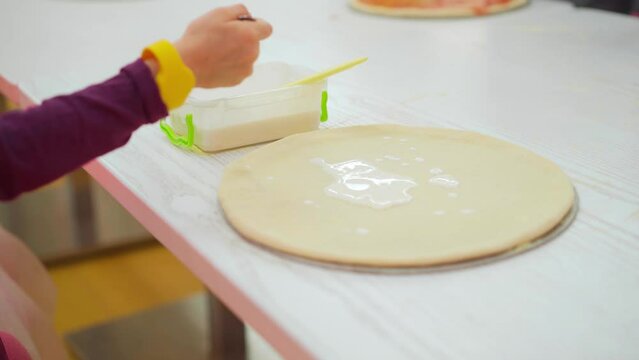 Workshop for little children how yo make pizza. Kids learning making pizza with chef teachers
