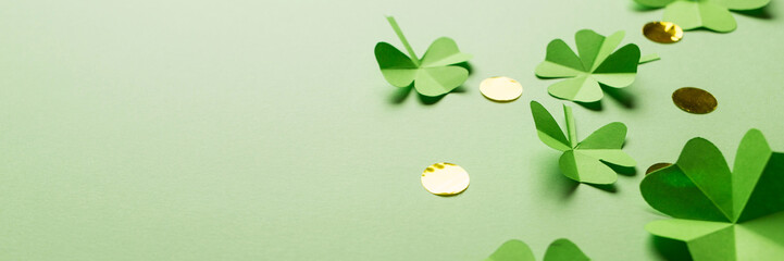 St. patrick's day. green background with clover leaves: shamrock and four-leafed, coin or confetti....