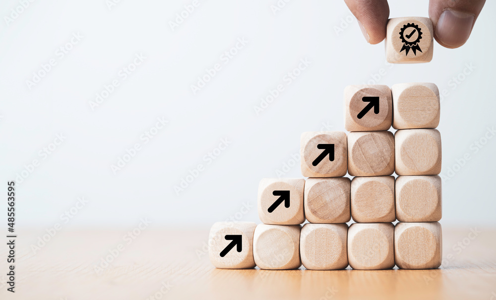 Poster Hand putting virtual quality assurance and arrow which print screen on wooden cube for quality enhancement of  guarantee product and ISO service concept.